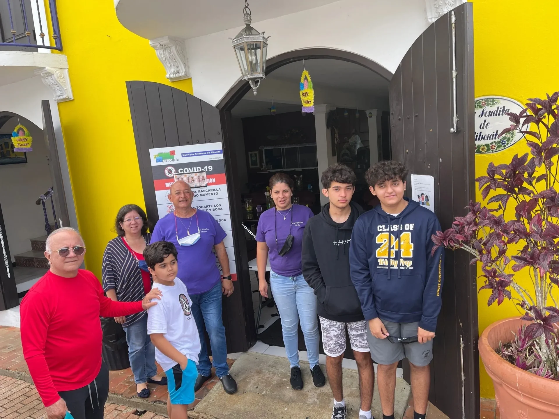 A group of people standing in front of a building.