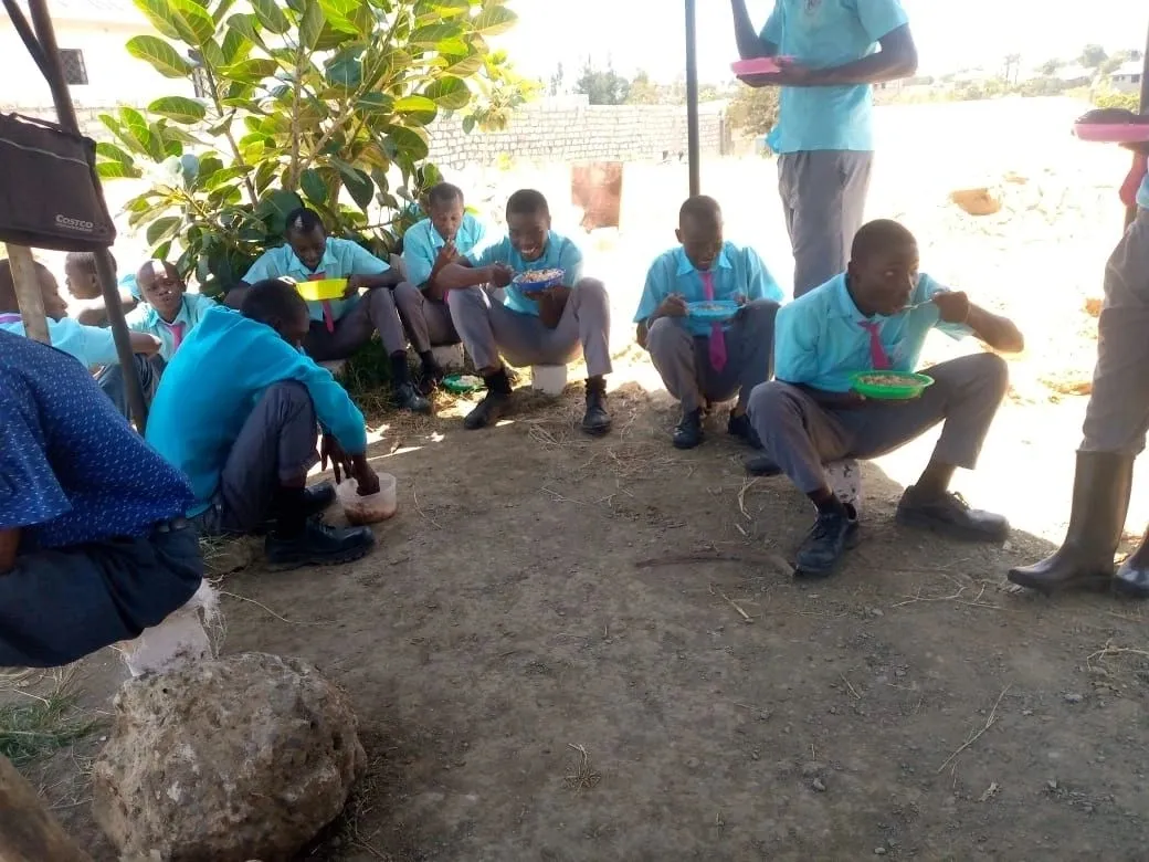 A group of people sitting on the ground.