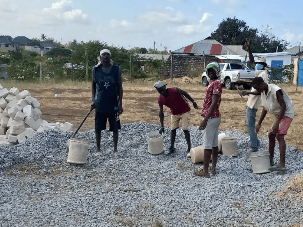 A group of people standing around some buckets