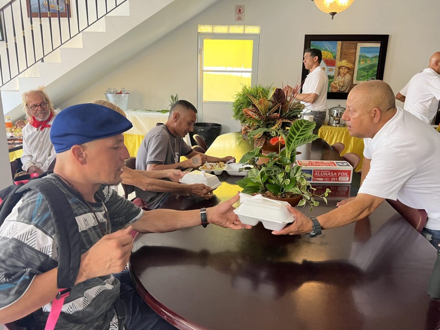 A group of people sitting at a table eating.